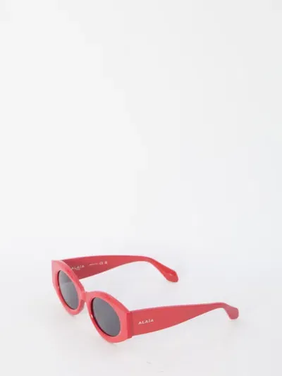 Alaïa Oval Sunglasses In Red